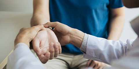 A doctor checks a patient's pulse